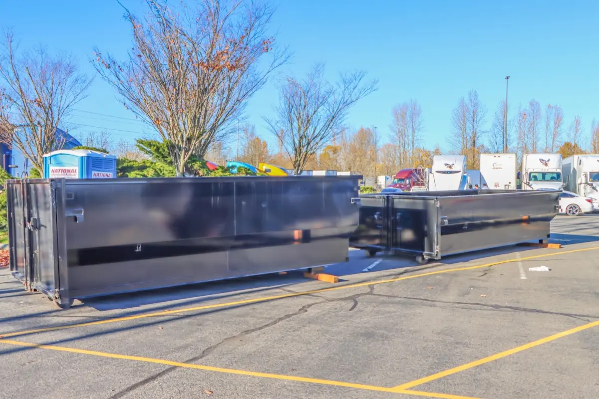 Professional dumpster rental service with roll-off container on residential driveway in Fairmont